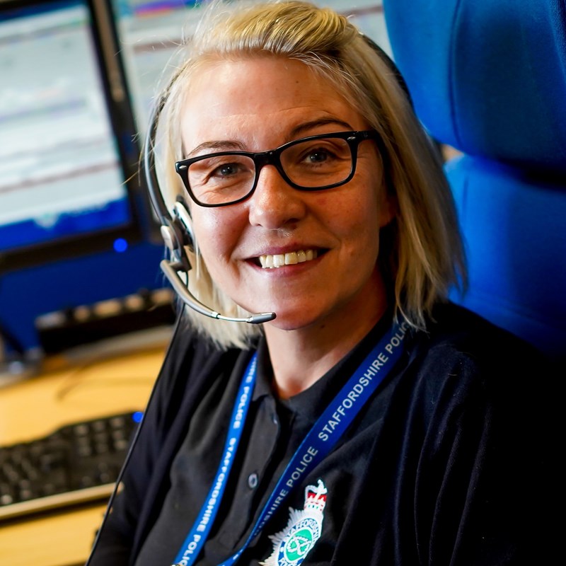 Call centre working smiling while sat at her desk
