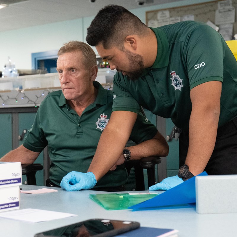 Two custody detention officers working at their desk