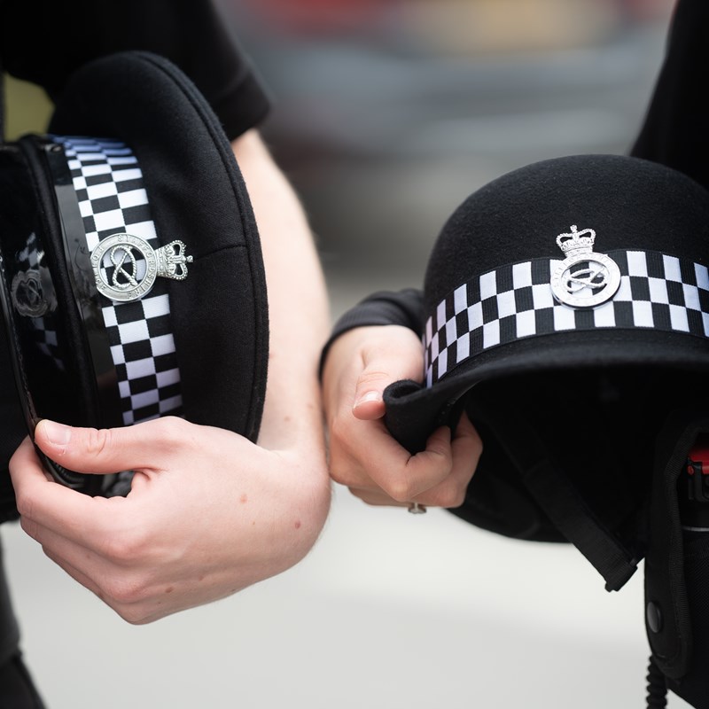 Close up of female and male police officer hats