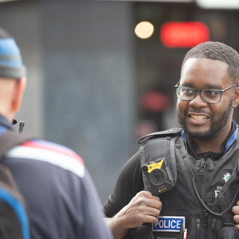 Black male officer talking to a member of the public